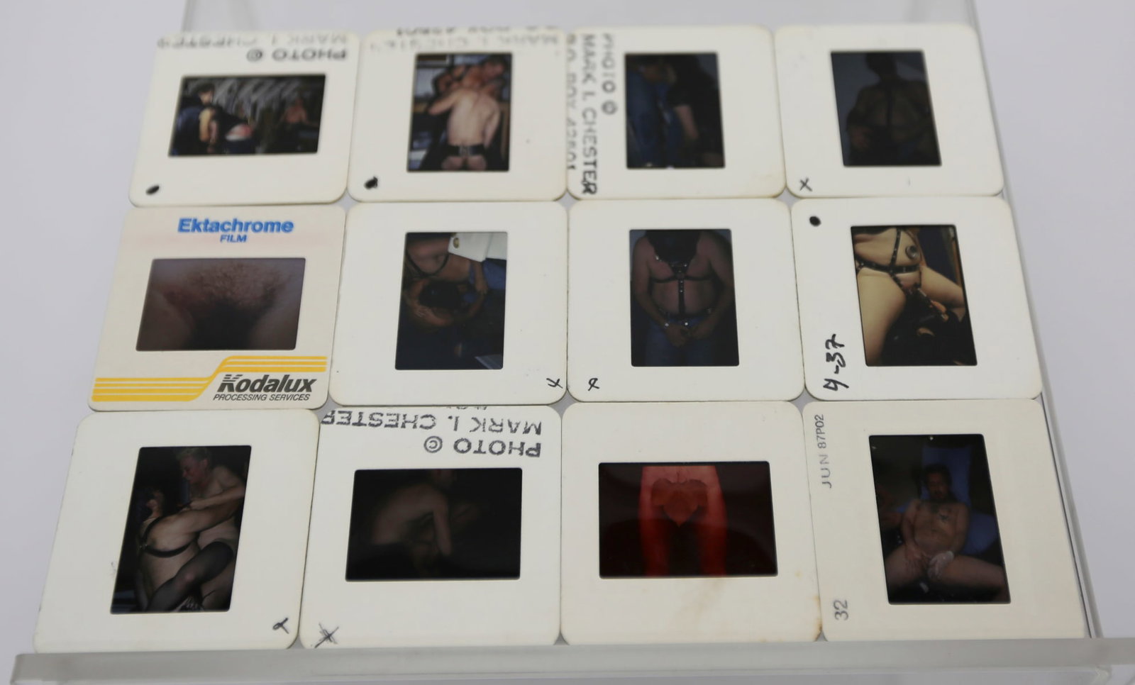 Mark I. Chester Male Erotic Color Slide Collection: Collection of 12 vintage color transparency slides featuring adult male erotic, bondage, and fetish-themed photography attributed to photographer Mark I. Chester. Includes Ektachrome and Kodalux-proce