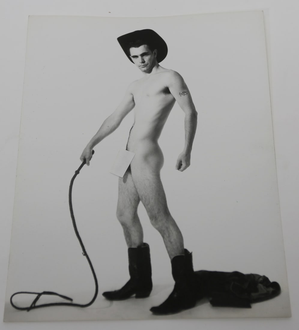Vintage Cowboy Male Physique Photograph: Vintage black and white male physique photograph depicting a nude model wearing a cowboy hat and boots while holding a whip in a studio setting. Measures approximately 10 by 8 inches. Shipping: Flat r