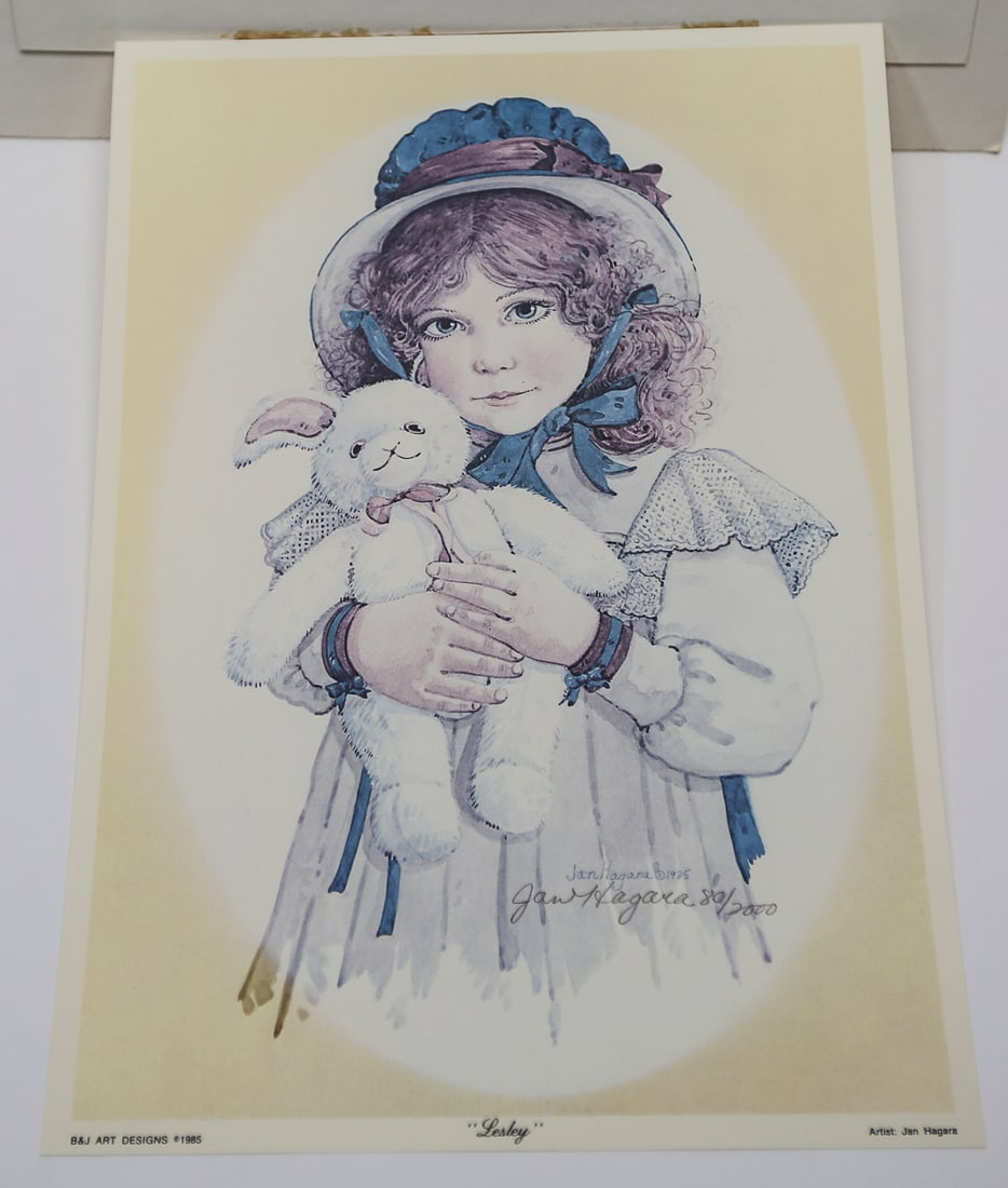 Jan Hagara Lesley Limited Edition Lithograph: A limited edition lithograph by Jan Hagara titled Lesley, depicting a young girl in a bonnet and lace-trimmed dress holding a plush rabbit. Signed and numbered 80 of 2000, dated 1985, and published by
