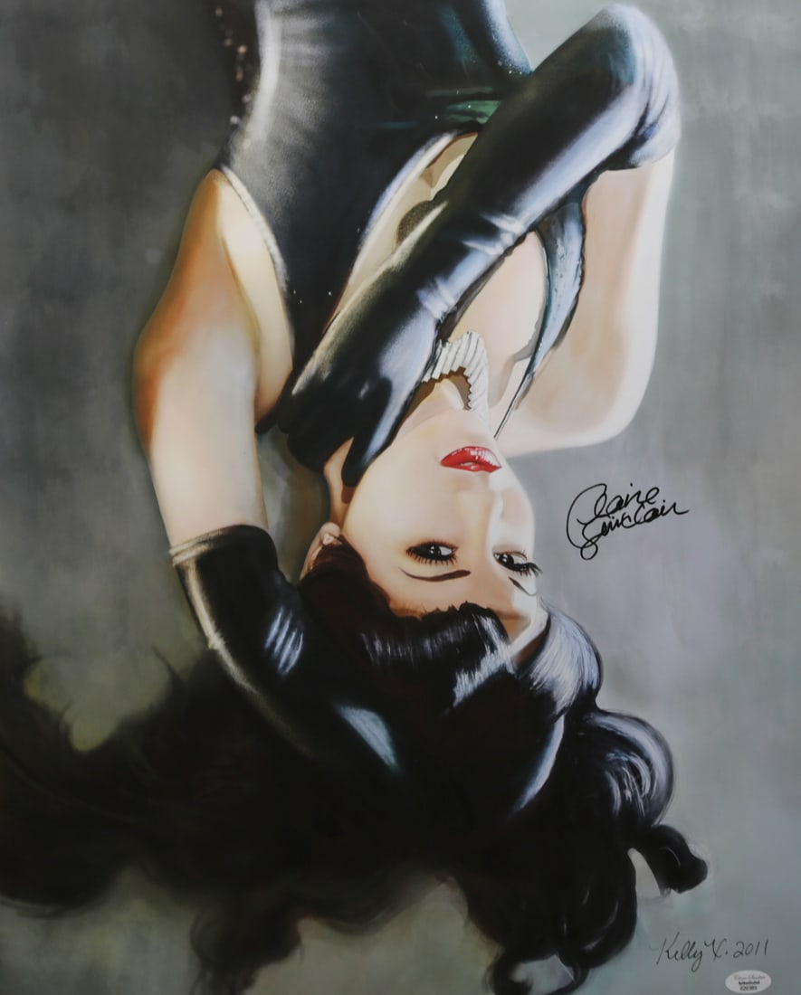 Claire Sinclair Signed Pinup Print: Pinup print depicting model Claire Sinclair in a dramatic reclining pose wearing a black costume and long gloves. Signed by Claire Sinclair and additionally signed Kelly V and dated 2011, with an