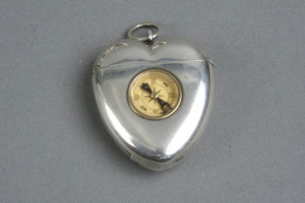 A Victorian silver heart shaped vesta case, 2ins: A Victorian silver heart shaped vesta case, with inset compass, Thomas Johnson, London, 1894, 2ins