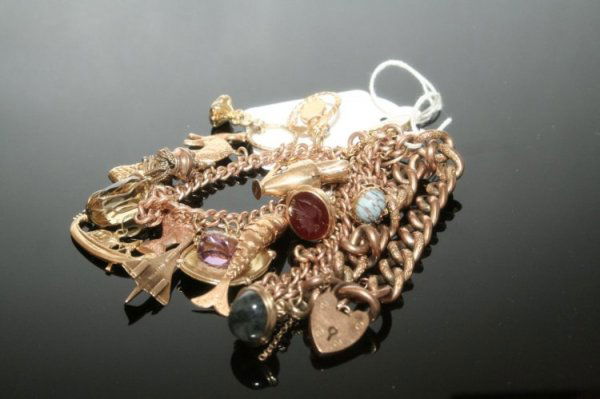 A 9ct gold curb link charm bracelet & 2 curb link: A 9ct gold curb link charm bracelet, hung seventeen varied charms, together with two further curb link bracelets, approximately 110 grams total