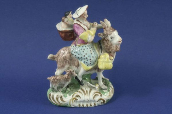 An early 19th century Staffordshire figure group,: An early 19th century Staffordshire figure group, based upon The Tailor's Wife, on scroll base, 5in.