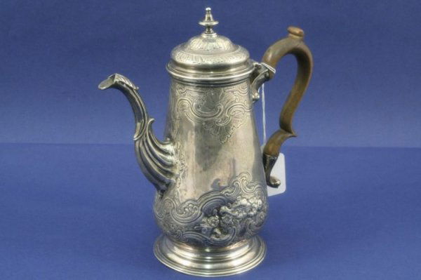 A George III silver coffee pot, 8.5ins.: A George III silver coffee pot, with turned finial, wooden scroll handle and decorated with scrolls and floral sprays, the base engraved "Ireson Westmin'r Tavern", Robert Brown, London 1742, (repairs)