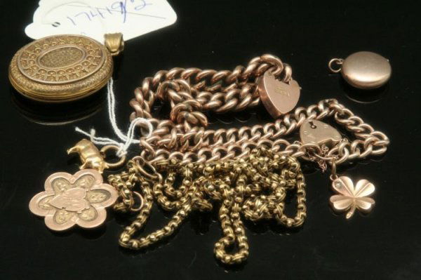 A 9ct gold four leaf clover charm, pig charm, 2 b: A 9ct gold four leaf clover charm, a gold pig charm, two gold curb link bracelets, lockets and medallion