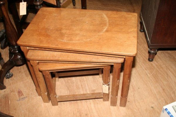 Robert 'Mouseman' Thompson, a nest of three carved: Robert 'Mouseman' Thompson, a nest of three carved oak tea tables, with octagonal legs and block feet, largest 2ft