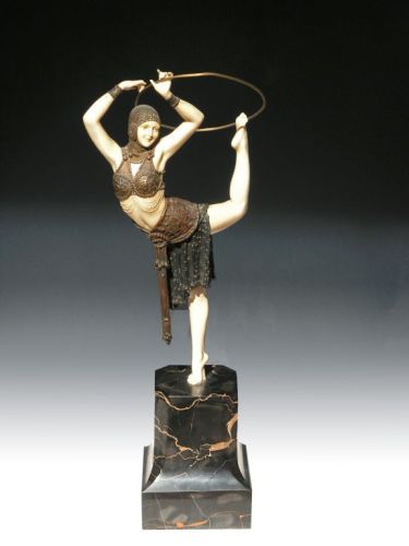 Demetre Chiparus, The Hoop Girl: A Demetre Chiparus bronze and ivory figure of 'The Hoop Girl', in two piece costume balanced on one foot holding a hoop with left foot and both hands on veined black marble base, with engraved D.H. Ch