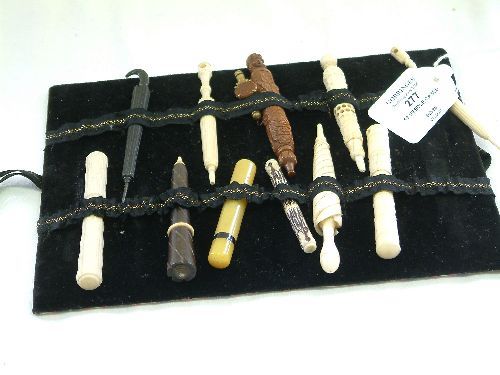 A collection of thirteen Victorian and later bone: A collection of thirteen Victorian and later bone and wood needle cases, six of which are carved as umbrellas