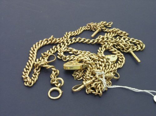 Two albert chains & 2 bracelets: Two albert chains, with bars, each 14.5ins long and two curb link bracelets with heart padlock clasps, approximately 155grms total.
