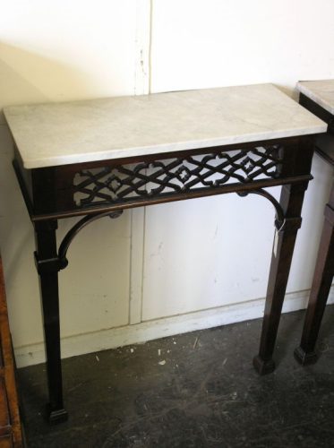 A pair of George III Chippendale design mahogany c: A pair of George III Chippendale design mahogany console tables, with veined white marble tops over pierced friezes and corner arches on square tapered legs, adapted, 2ft 6ins