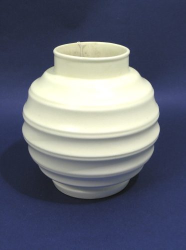 A globular vase in the style of Keith Murray for W: A globular vase in the style of Keith Murray for Wedgwood, cream-glazed moonstone-type with horizontal ribbing, 7.25in.
