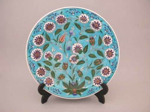 A large Theodore Deck stoneware charger: A large Theodore Deck stoneware charger, having all-over floral Iznik decoration on a turquoise ground, marks to underside with the impressed signature T. Deck, Dia. 50cm