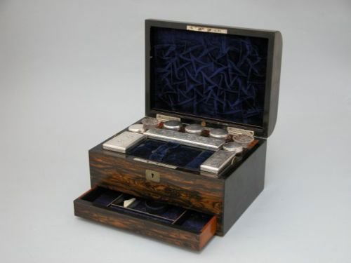 A Victorian coromandel toilet case: A Victorian coromandel toilet case, the hinged lid bearing cartouche engraved 'Minden Rose' and opening to reveal fully fitted interior, complete with glass bottles with plated lids and fitted drawer