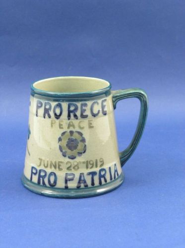 A Moorcroft mug, 1919, 3.75in.: A Moorcroft mug, 1919, commemorating Peace following World War One, inscribed Pro Rece, Pro Patria, June 28th, 1919, painted initials and impressed mark, and painted inscription 'From ... Liberty', 3.