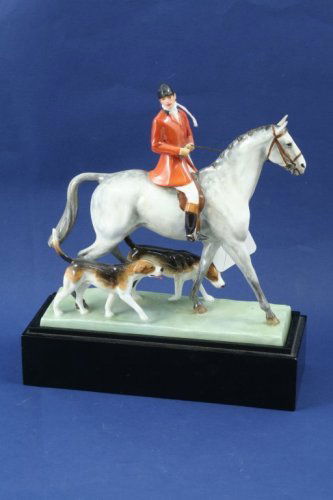 A Royal Worcester porcelain group, 7ins: A Royal Worcester porcelain group, of 'Huntsman & Hounds' modelled by Doris Lindner, Rd No 806514, model no.3115, on ebonised base, 7ins