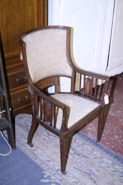 An Edwardian inlaid mahogany elbow chair,