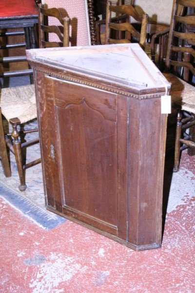 A George III oak hanging corner cupboard, 2ft 6in