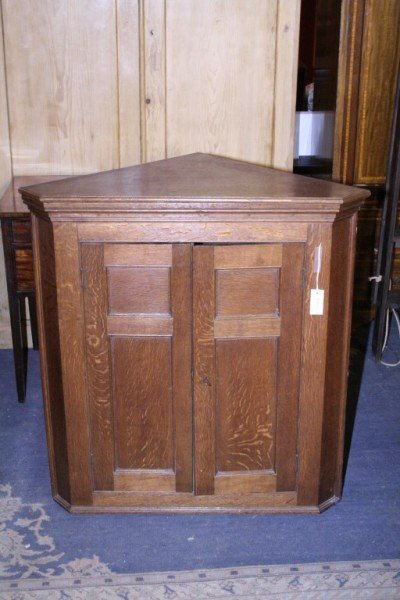 A George III oak hanging corner cupboard, 3ft 1in
