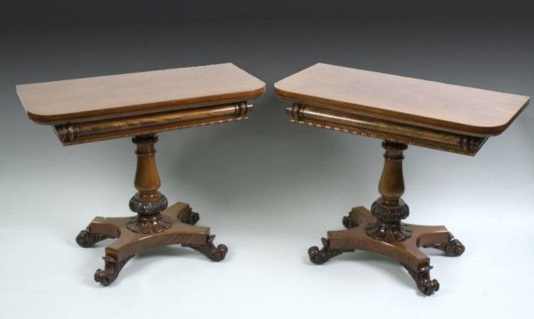 A pair of early Victorian mahogany tea tables, 3f: A pair of early Victorian mahogany tea tables, with folding D shaped tops and foliate carved stems with saltire platforms and scroll feet, 3ft