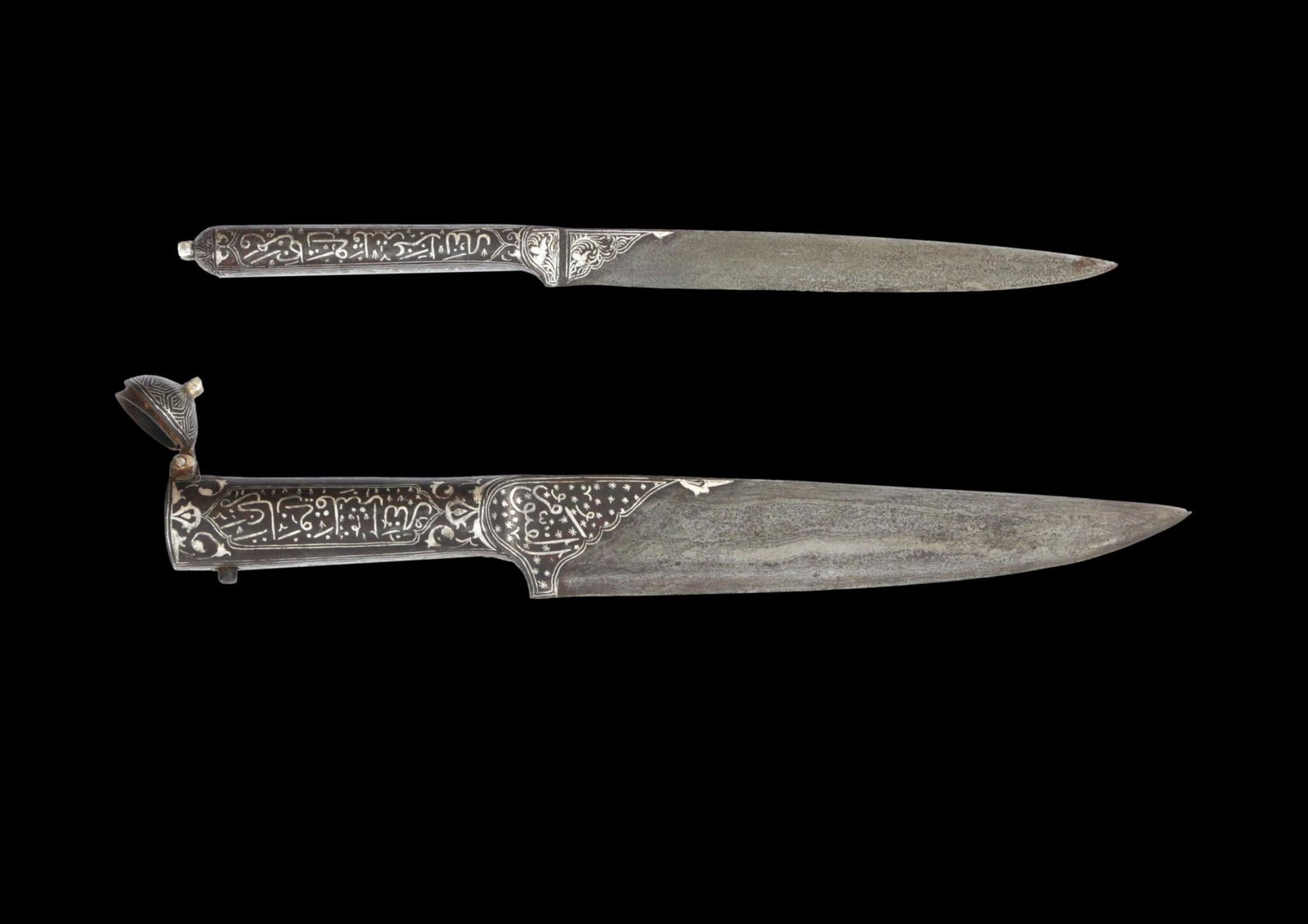 Set of 2 Indopersian Daggers, late 19th century: Set of 2 Indopersian Daggers, late 19th century, with attractive genuine silver damascening in Arabic calligraphy on both hilts and on both sides of their Damascus pattern blades. The larger dagger of