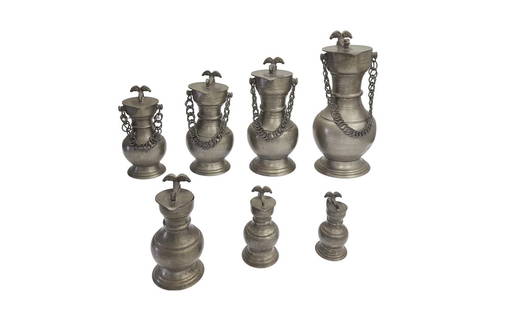 Antique Collection of 19th Century Swiss Pewter Flagons: This wonderful collection of 19th Century pewter flagons features spreading necks, bulbous bodies, and hinged pointed lids with double rams head thumb rests. Some flagons of the collection have