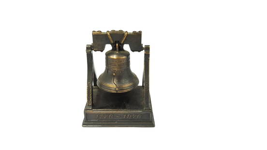 Cast Metal Pencil Sharpener in Form of the Liberty Bell: Cast metal pencil sharpener in the form of the Liberty Bell, with a dark bronze finish. Bell swings back and forth in order to make a little clang. Dimensions: ca. 7 cm x 5.5 cm x 4.5 cm. Condition: