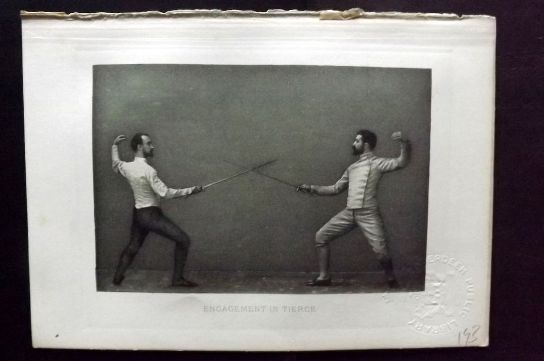 Badminton Library 1889 Antique Sword Fencing Print. Encampment in Tierce: Photogravure Published 1889, London for "The Badminton Library of Sports and Pastimes..." by Walter H. Pollock, E. B. Michell, and Walter Armstrong.Paper Size: 7.5 x 5 inch (19 x 13cm) Discrete Librar