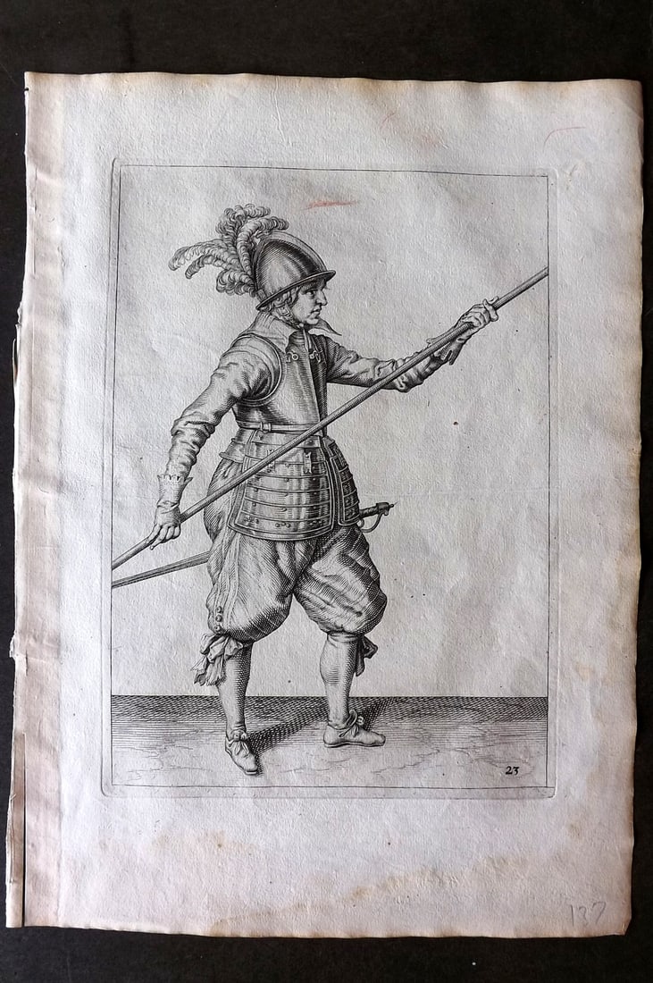 Gheyn, Jacob de 1608 Folio Military Print. Pikeman 23: Folio Copper Plate Published 1608, The Hague for "The Exercise of Arms, for Calivres, Muskettes and Pikes" by Jacob de Gheyn. Paper Size: 14 x 10 inch (36 x 25cm) Very minor margin water staining. Goo