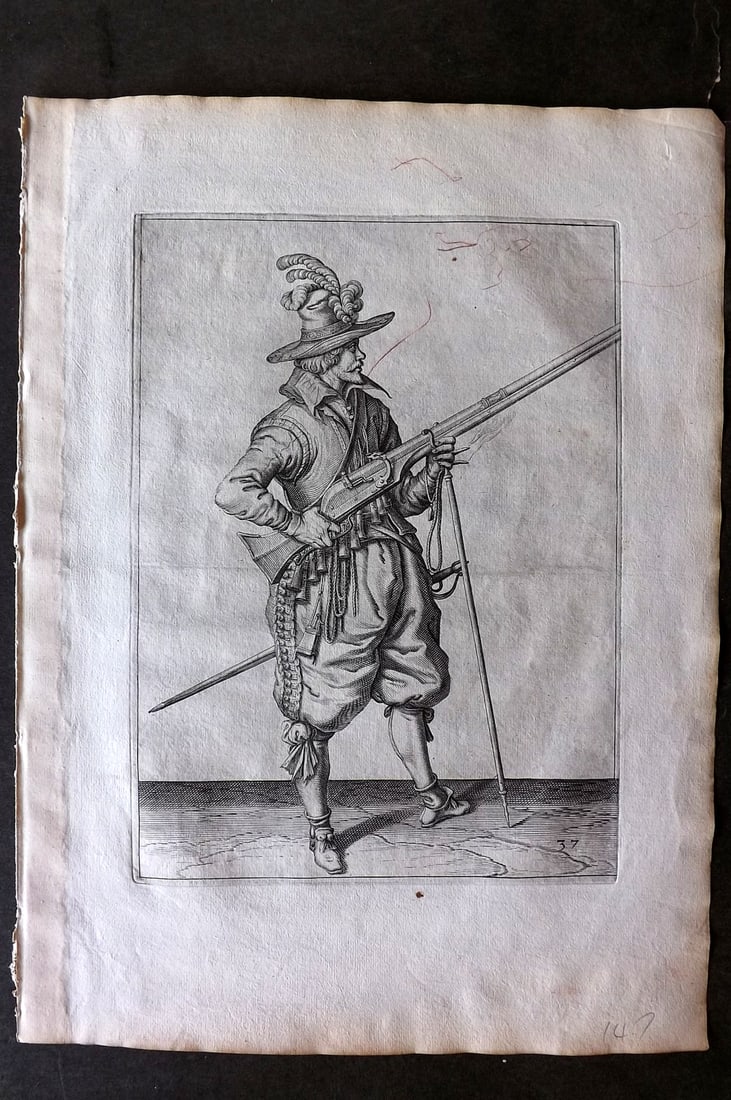 Gheyn, Jacob de 1608 Folio Military Print. Musketeer 37: Folio Copper Plate Published 1608, The Hague for "The Exercise of Arms, for Calivres, Muskettes and Pikes" by Jacob de Gheyn. Paper Size: 14 x 10 inch (36 x 25cm) Some red marks at top, otherwise Good
