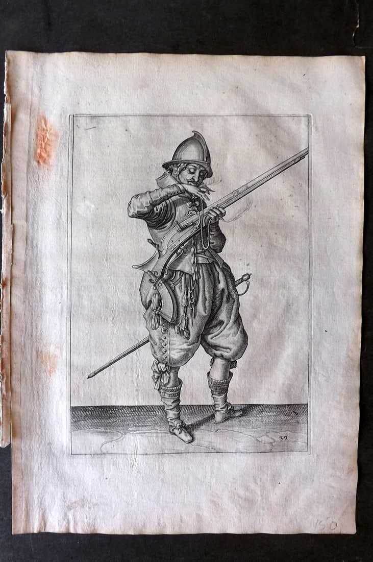 Gheyn, Jacob de 1608 Folio Military Print. Musketeer 39*: Folio Copper Plate Published 1608, The Hague for "The Exercise of Arms, for Calivres, Muskettes and Pikes" by Jacob de Gheyn. Paper Size: 14 x 10 inch (36 x 25cm) Some red marks in margin and minor sp