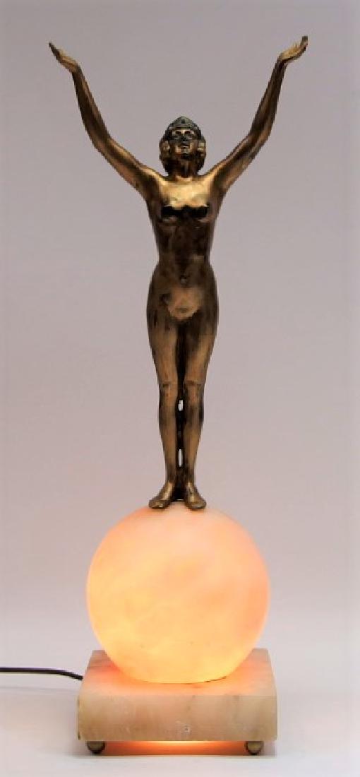 Czech Art Deco Alabaster & Patinated Metal Lamp: CZECHOSLOVAKIA, CIRCA 1920 A Czech Art Deco carved alabaster and patinated metal figural table lamp. The globe form shade sits on a alabaster plinth with metal ball feet supporting a patinated metal n