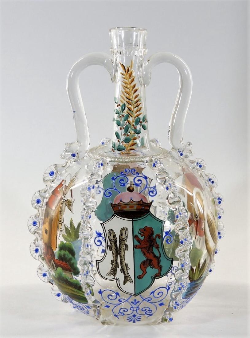 Czech Moser Enamel Decorated Armorial Decanter: CZECHOSLOVAKIA, EARLY 20TH CENTURY A fine Moser enamel decorated armorial decanter. The decanter is decorated with a family crest of two fish and a lion flanked by a windmill and crane on each side se