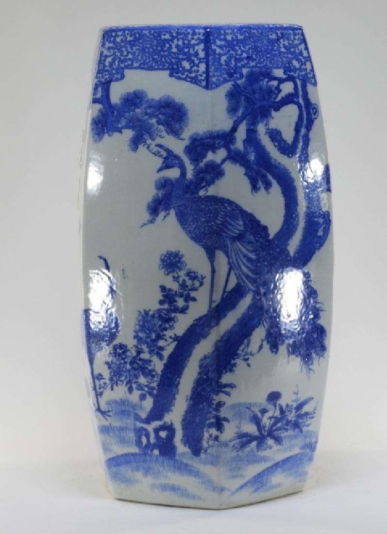 Japanese Blue & White Porcelain Garden Seat: JAPAN, EARLY 20TH CENTURY A Japanese blue and white porcelain garden seat. The seat is decorated with a male and female peacock with the male perched in a tree surrounded by flowers with two butterfli