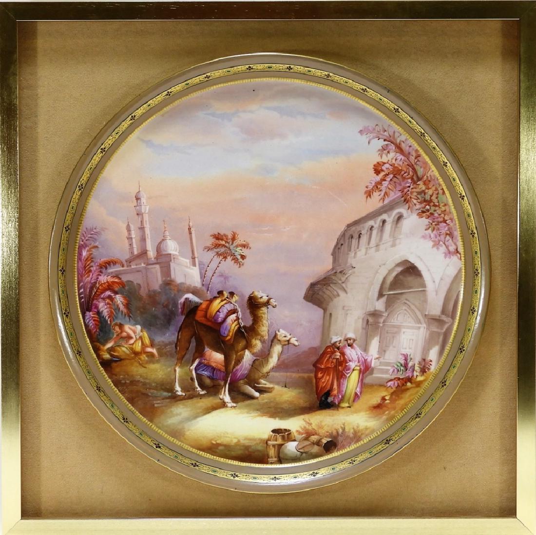 German Porcelain Orientalist Decorated Charger: GERMANY, 19TH CENTURY A German porcelain Orientalist decorated charger. The charger is decorated with two robed men recently dismounted from their camels standing amongst Moorish architecture. Notice 