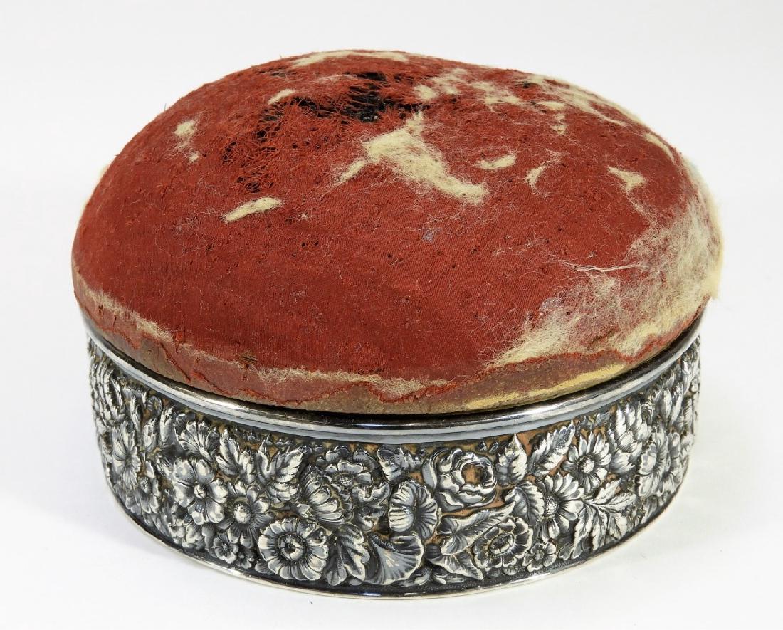 Tiffany & Co. Silver Soldered Floral Pin Cushion: NEW YORK, SECOND HALF 19TH CENTURY A silver soldered and plated floral pin cushion sewing box manufactured by Tiffany & Co., form number 2591. The box is decorated with an embossed band of flowers and