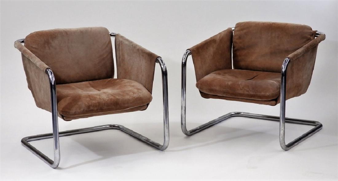PR MCM Brown Suede Tubular Chrome Sling Chairs: UNITED STATES, CIRCA 1950 A pair of American mid century modern brown suede tubular chrome sling chairs. The seats are padded. Dimensions : 30" tall by 28 1/2" wide by 30" deep and a 14" seat height