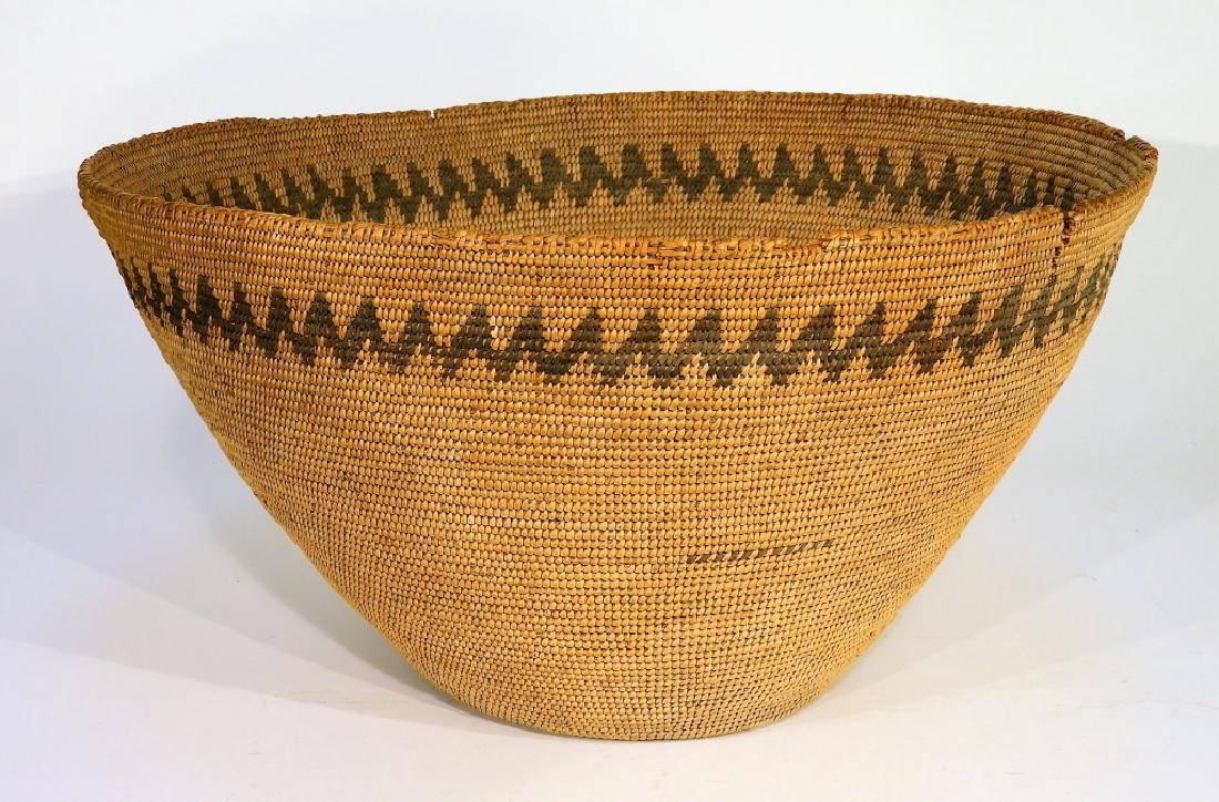 Antique Native American Woven Utility Basket: UNITED STATES, LATE 19TH-EARLY 20TH CENTURY An antique Native American woven utility basket. The basket was woven with a rightward coil direction originating from a center pinhole. The basket is decor