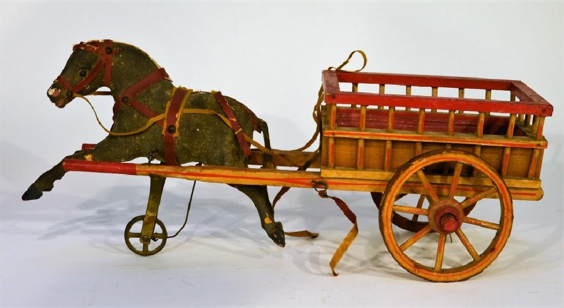 19C. German Papier Mache Horse & Carriage Pull Toy: GERMANY, 19TH CENTURY A German papier mache horse and carriage pull toy. The horse is balanced on a single wheel that when moved emulates the galloping motion of a horse. The wooden carriage is red pa