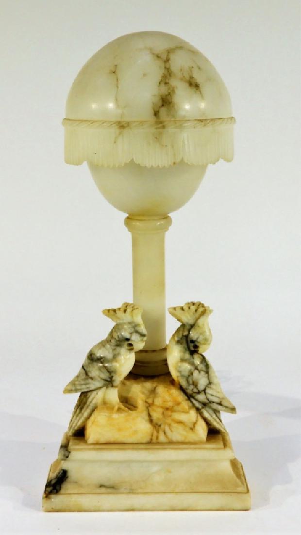 American Art Deco Alabaster & Marble Cockatoo Lamp: UNITED STATES, EARLY 20TH CENTURY An American Art Deco alabaster and carved marble table lamp. The lamp sits on a beveled marble base decorated with two cockatoos carved from a single stone supporting