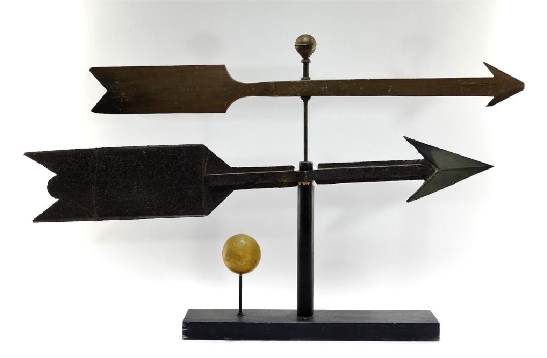 2 C.1900 American Folk Art Primitive Arrow Vanes: UNITED STATES, CIRCA 1900 Two American Folk Art primitive arrow form weathervanes. The lot includes a carved wood and pressed sheet steel vane. Dimensions : Wooden arrow measures 36", iron arrow measu