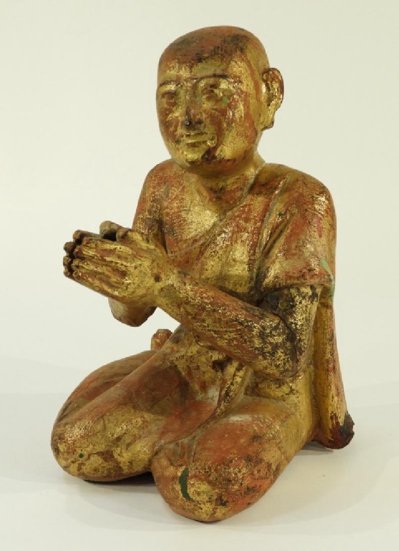 19C. Chinese Carved Gilt Wood Buddhist Monk: CHINA, 19TH CENTURY A Chinese carved and gilt wood Buddhist monk. The monk is depicted kneeling with his palms together wearing a Saffron robe. Dimensions : 10 1/2" tall