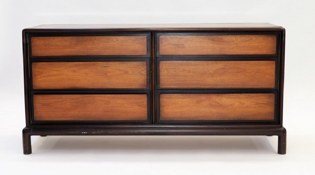 John Stuart Inc. MCM Asiatic Low Dresser: NEW YORK/MICHIGAN, CIRCA 1950 A mid century modern Asiatic low dresser retailed by John Stuart Inc. The dresser sits on a rounded frame with stout legs rising into a rectangular case with incised pane