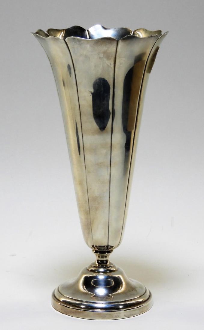 Wallace Silver Arts & Crafts Floriform Vase: CONNECTICUT, CIRCA 1915 An Arts and Crafts sterling silver floriform vase crafted by Wallace Silversmiths of Wallingford, Connecticut. The vase stands on a stepped beveled base rising into an elegantl