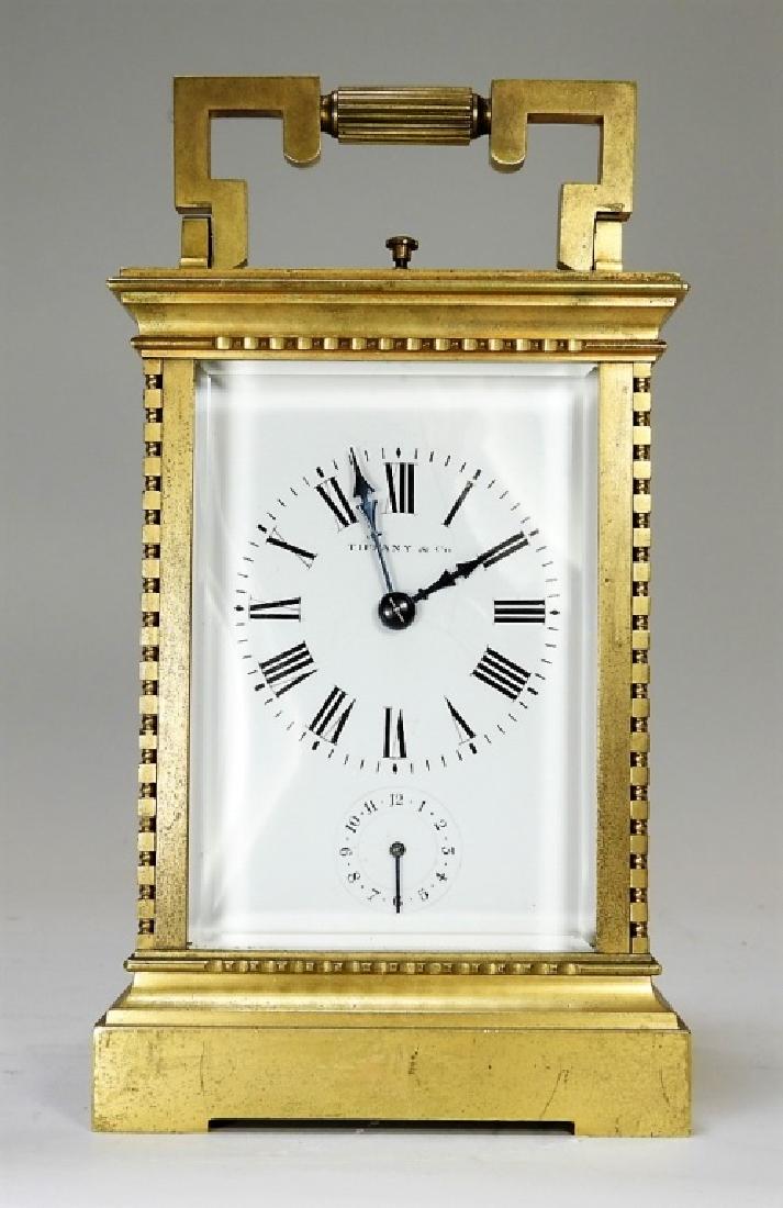 FINE Tiffany & Co Grand Sonnerie Repeater Clock: France, New York,Late 19th Century Gilt bronze carriage clock retailed by Tiffany & Co., New York, grande sonnerie movement with repeater and open top escapement. Gilt bronze, beveled glass Signed "Ti