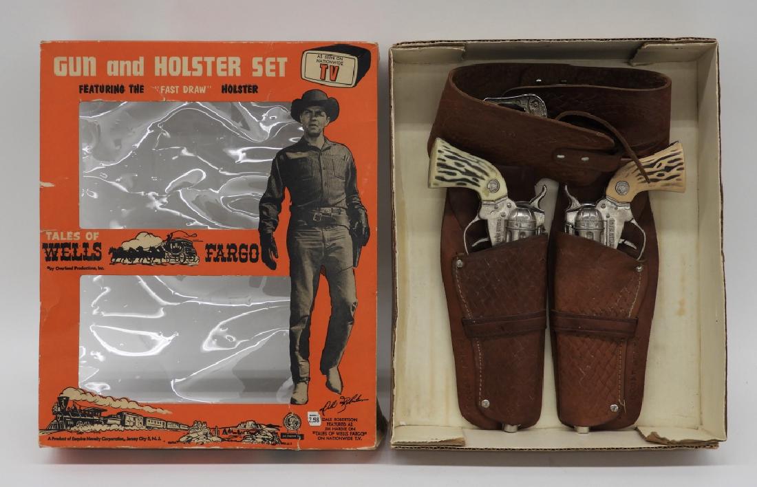 Wells Fargo Dale Robertson Jim Hardie Cap Gun Set: United States,Mid 20th Century As seen on T.V. Tales of Wells Fargo Dale Robertson as Jim Hardie fast draw holster set. Brown tooled leather holster with Wells Fargo Logo and basket weave design. The