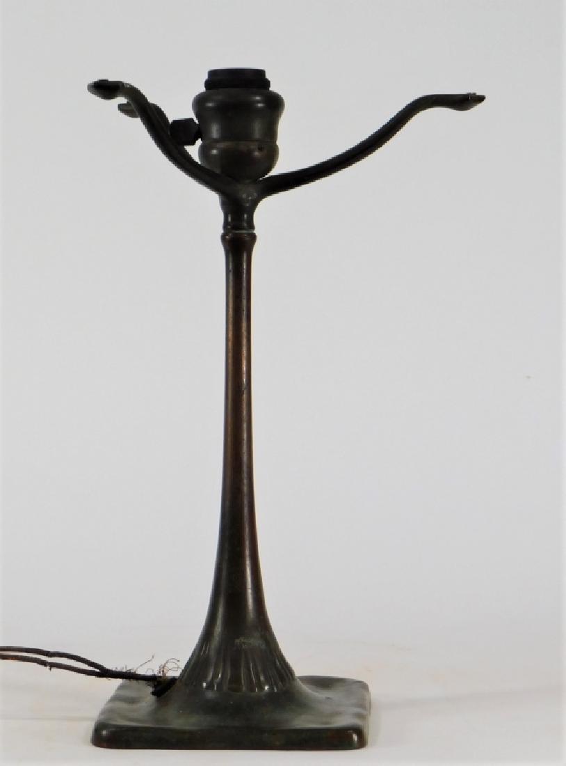 Tiffany Studios Art Nouveau Bronze Table Lamp Base: New York,Early 20th Century Three arm shade support on a tapered organic shaft with raised floriform design on a square base finished in a dark mottled patination. Bronze,14" tall x 5 1/2" at base., O