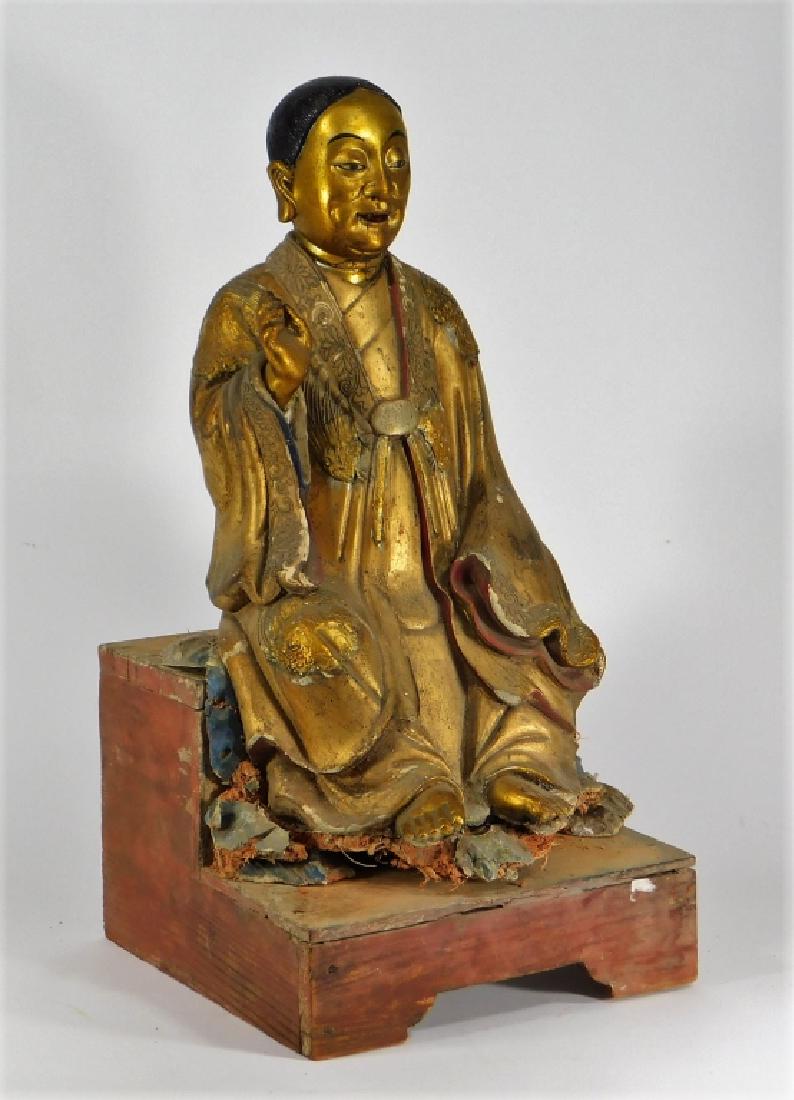 18C. Chinese Gilt Stucco Seated Buddha Figure: China,18th Century Finely sculpted and gilt figure of a seated Buddha with relief decorated robe of florals, tendrils, and birds. Stucco, wood,20" tall x 9 3/4" wide on base, Losses to stucco and fibe