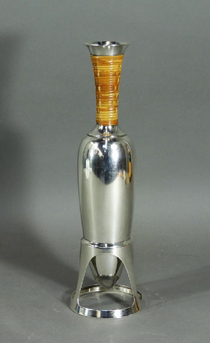 Gorham Sterling Silver Japonesque Amphora Vessel: ,Rhode Island,Early 20th Century Sterling silver amphora type vessel with corsetted rattan wrapped neck on stand, the Japonesque aesthetic makes us believe it was potentially used to serve Sake. Sterl