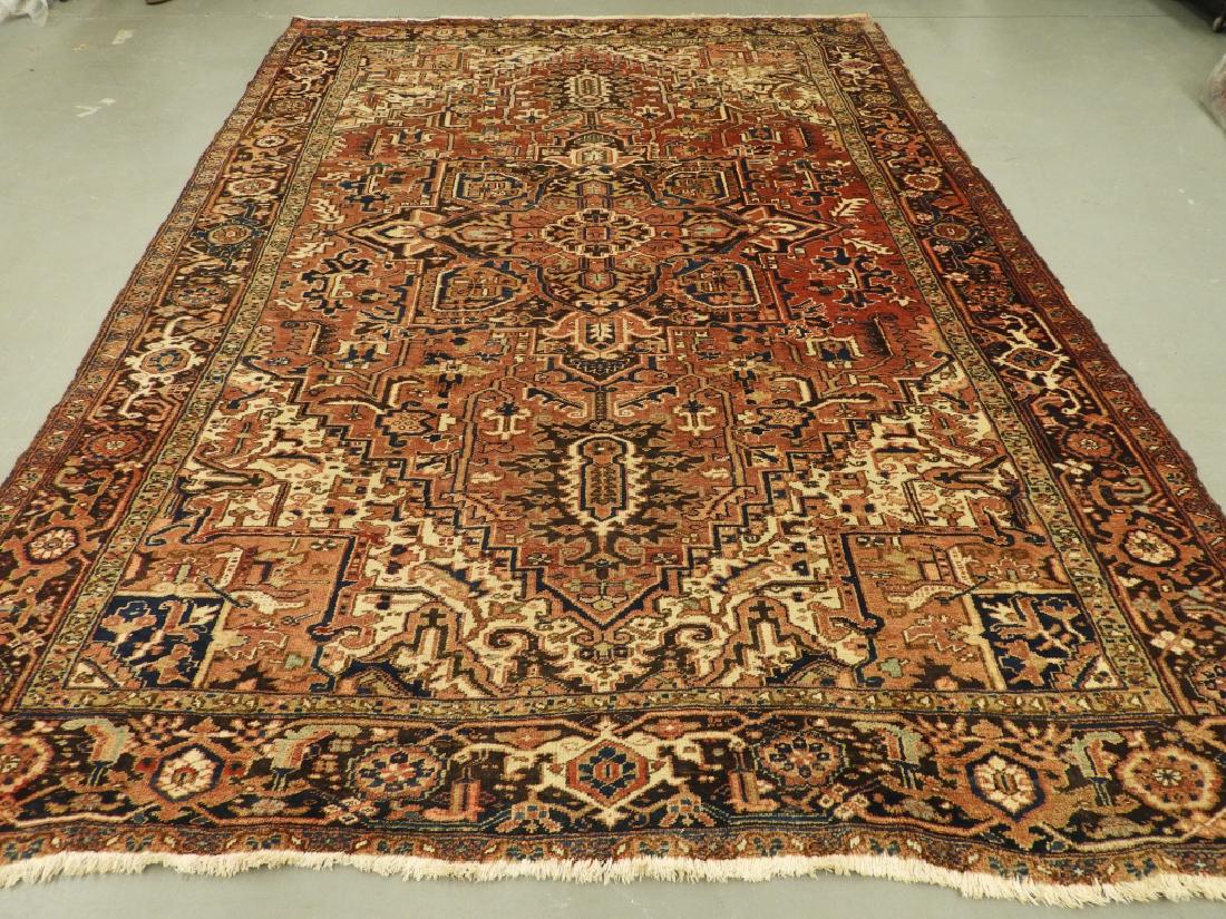 C.1940 Persian Middle Eastern Heriz Carpet Rug: ,Persia,Circa 1940 Red field with center floral medallion surrounded by an allover floral tendril pattern within earthly geometric floral border. Wool,13'4" x 9'6", From a Cape Cod, Massachusetts esta