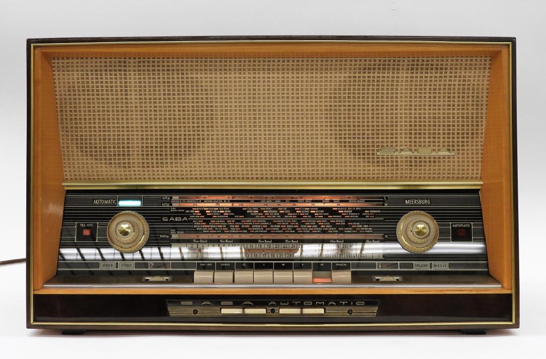 Saba Meersburg Automatic 125 AM/FM Radio Stereo: ,Germany,Circa 1950 Short wave AM/FM radio manufactured by Saba-Meersburg finished in a medium brown veneer case. Wood, metal, and plastic,15" tall x 24 3/4" wide x 10 1/2" deep, From the collection o